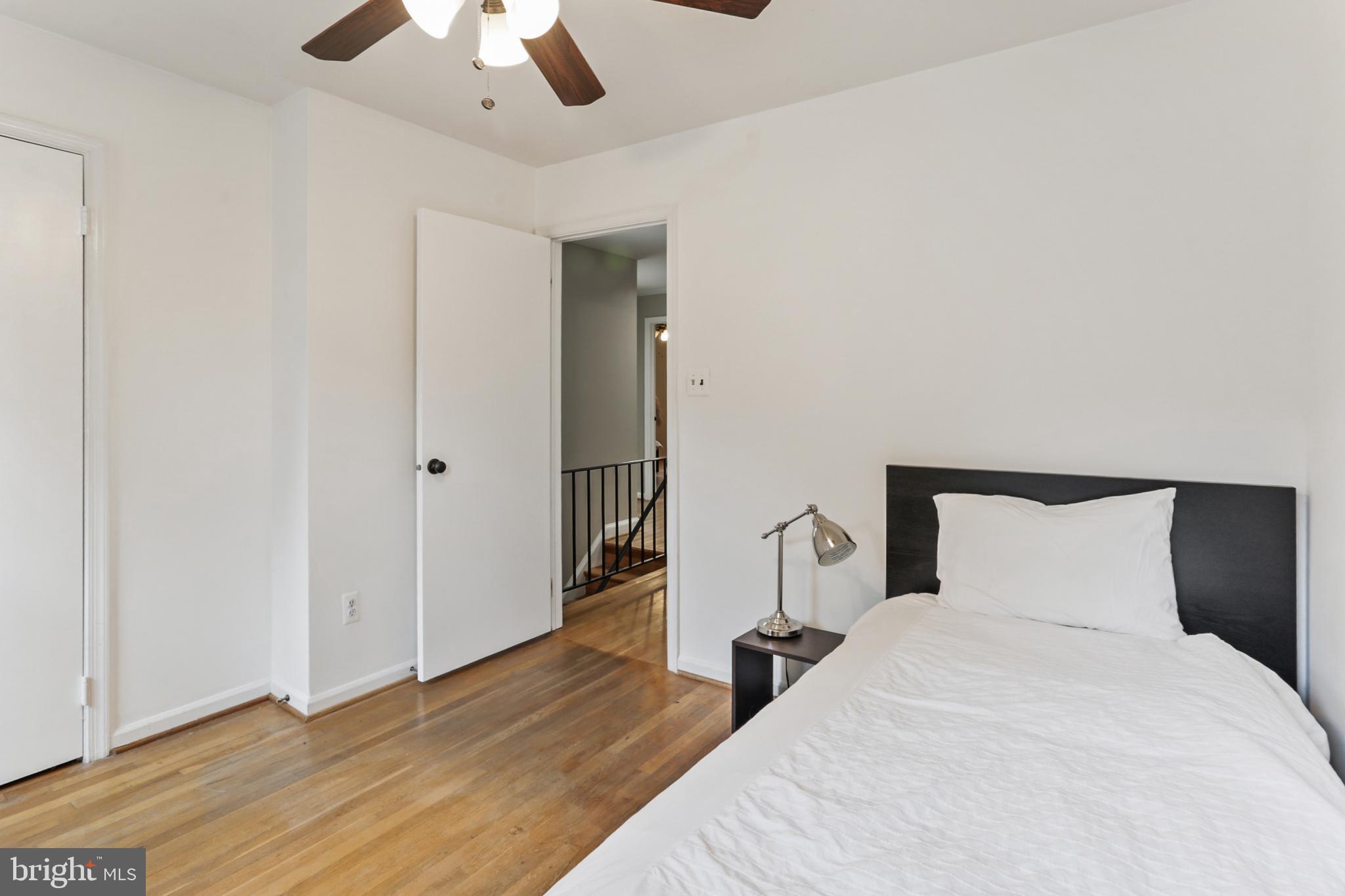 10233 Gainsborough Road Potomac, MD 20854 - Photo 29 of 50 a bedroom with a bed and a chandelier