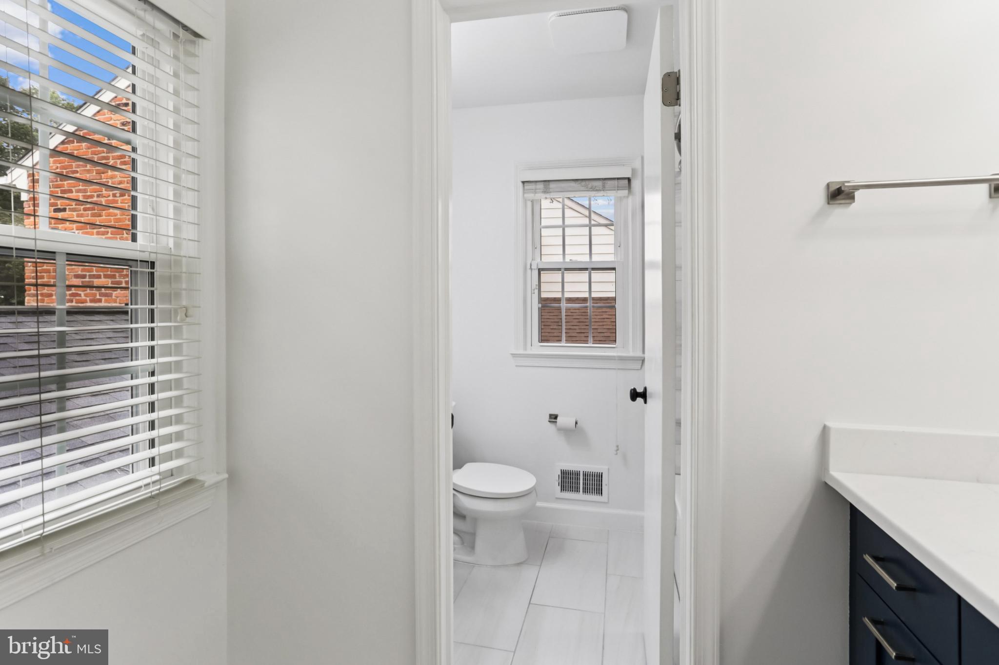 10233 Gainsborough Road Potomac, MD 20854 - Photo 30 of 50 a bathroom with a toilet sink and a window