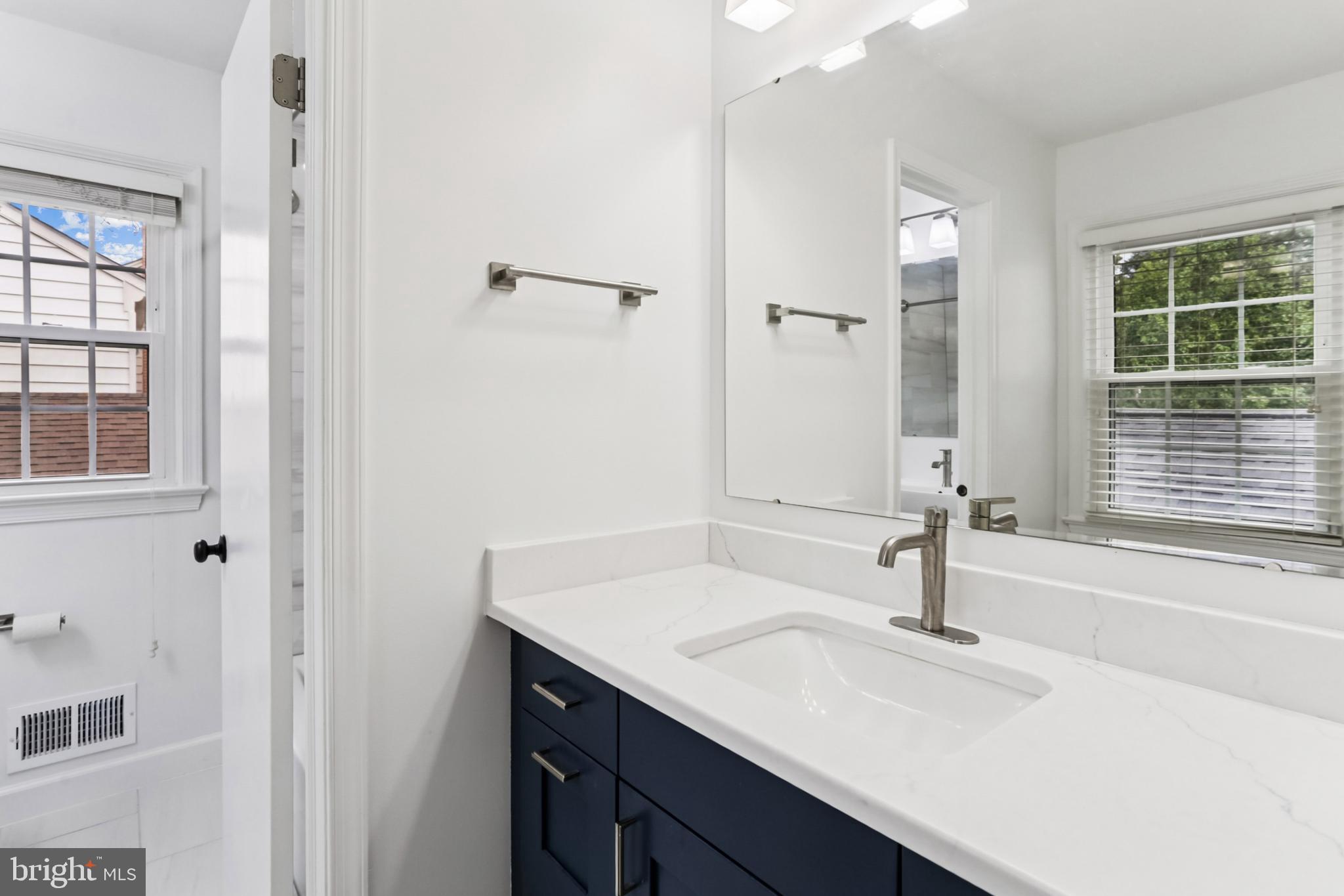 10233 Gainsborough Road Potomac, MD 20854 - Photo 31 of 50 a bathroom with a sink and a mirror