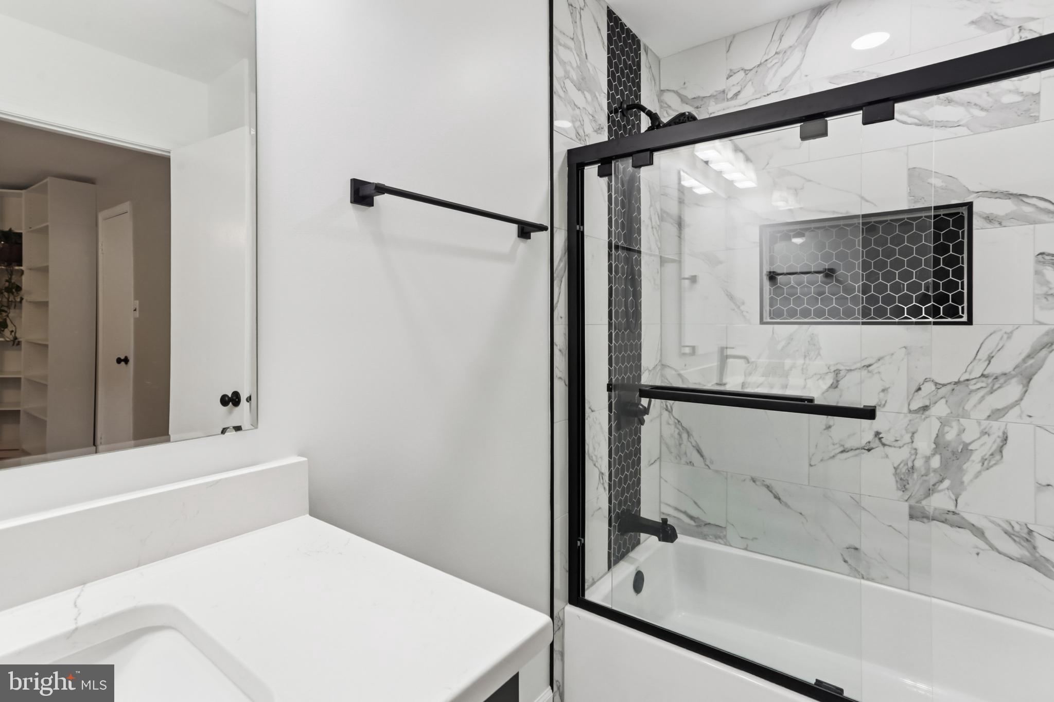 10233 Gainsborough Road Potomac, MD 20854 - Photo 36 of 50 a bathroom with a bathtub and a shower