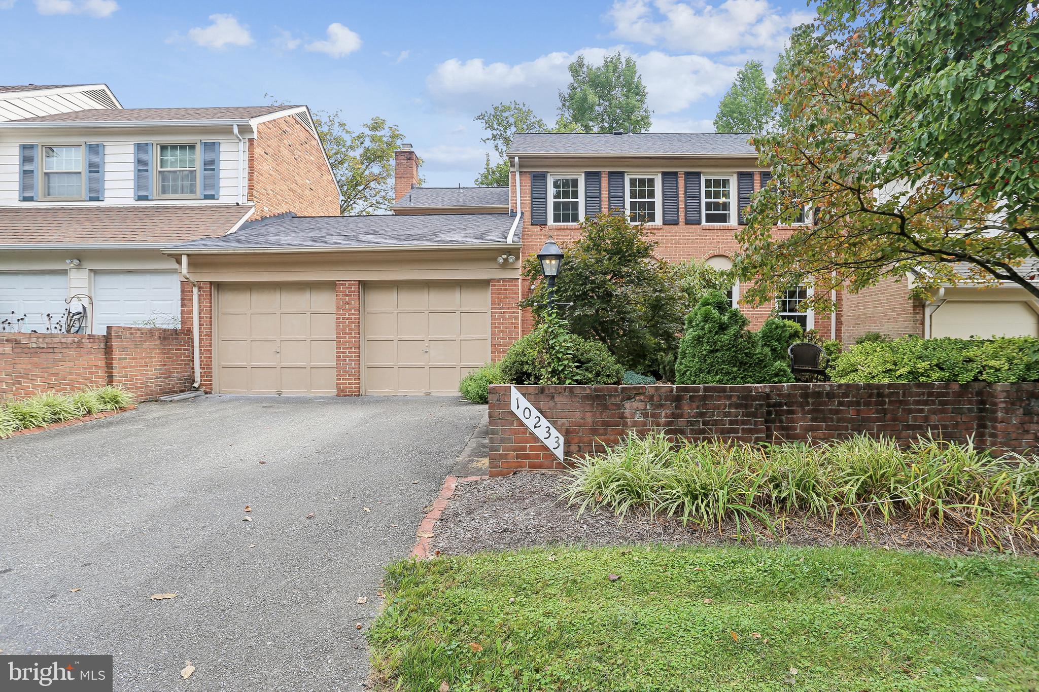 10233 Gainsborough Road Potomac, MD 20854 - Photo 4 of 50 a front view of a house with a yard and garage