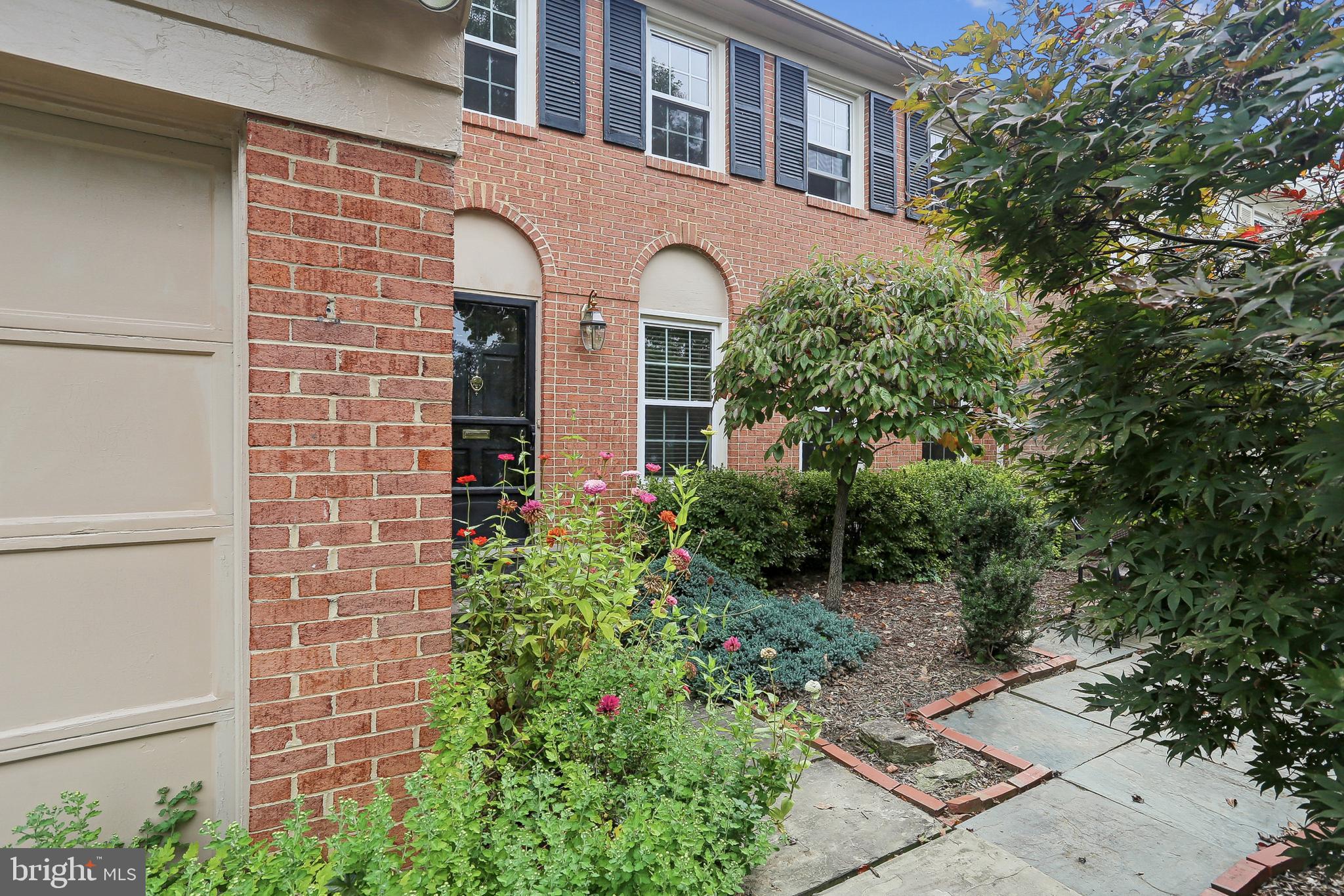 10233 Gainsborough Road Potomac, MD 20854 - Photo 5 of 50 a front view of a house with a garden