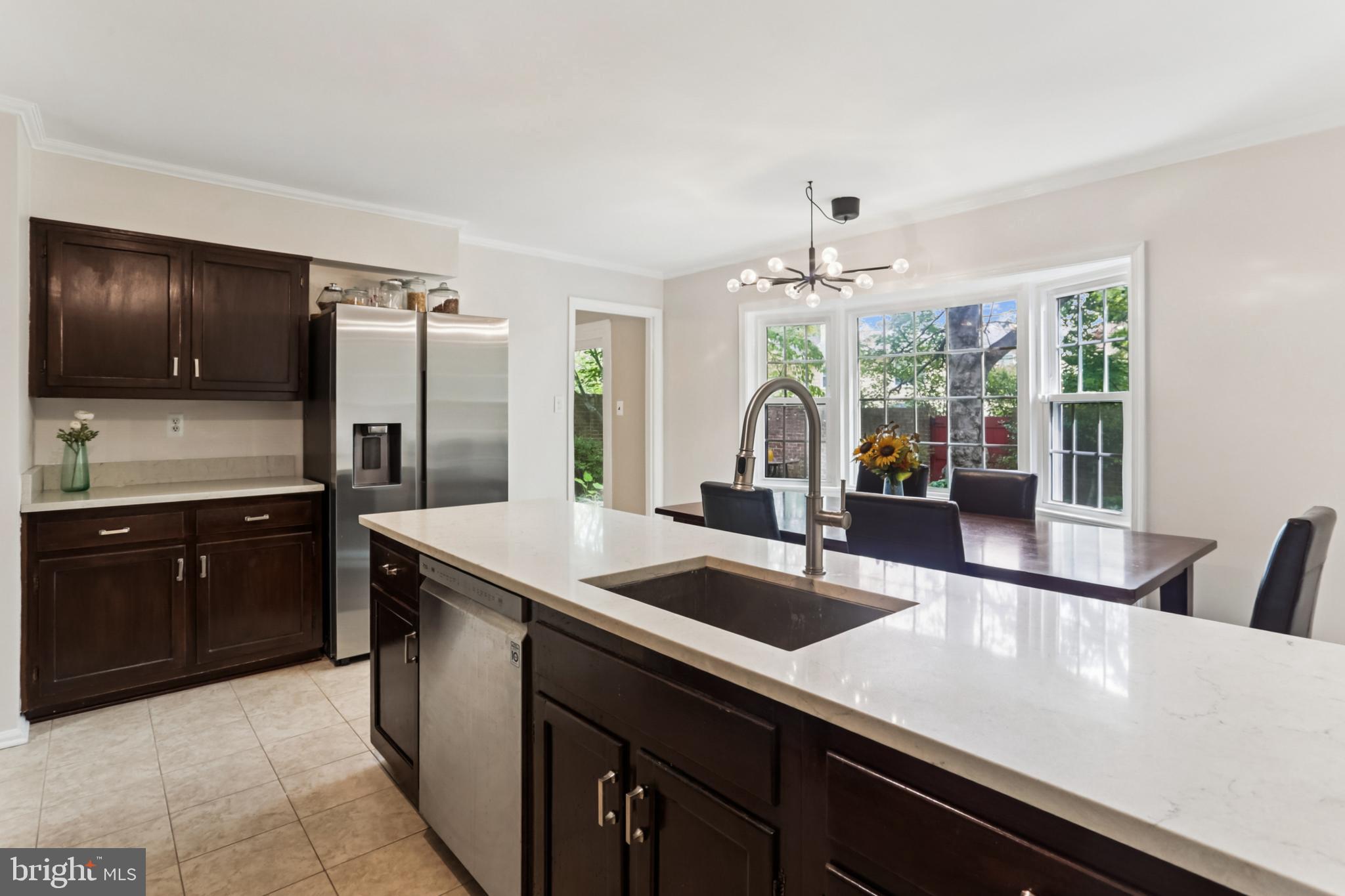 10233 Gainsborough Road Potomac, MD 20854 - Photo 7 of 50 a kitchen with a sink and a refrigerator