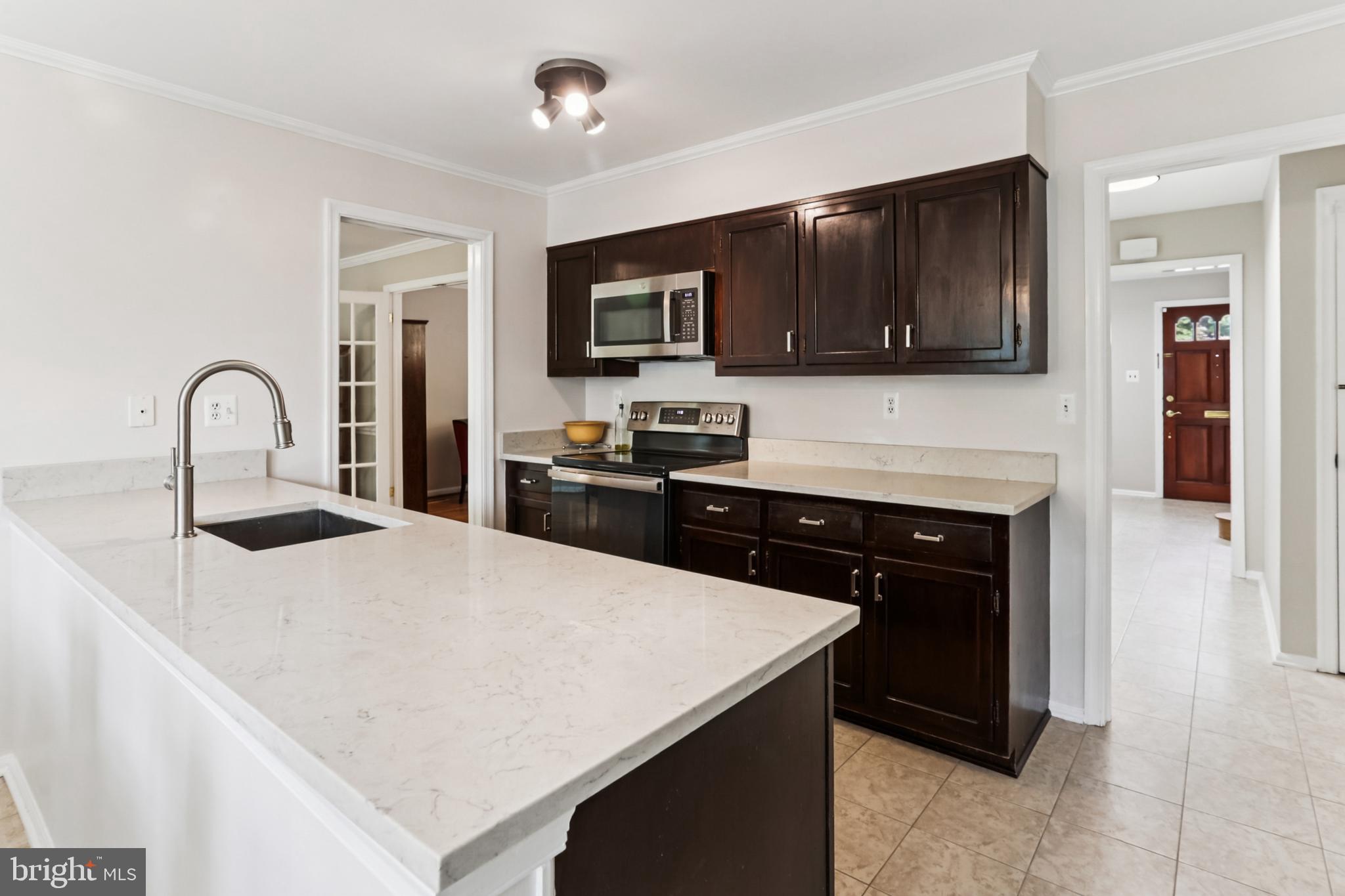 10233 Gainsborough Road Potomac, MD 20854 - Photo 8 of 50 a kitchen with a refrigerator and a stove top oven