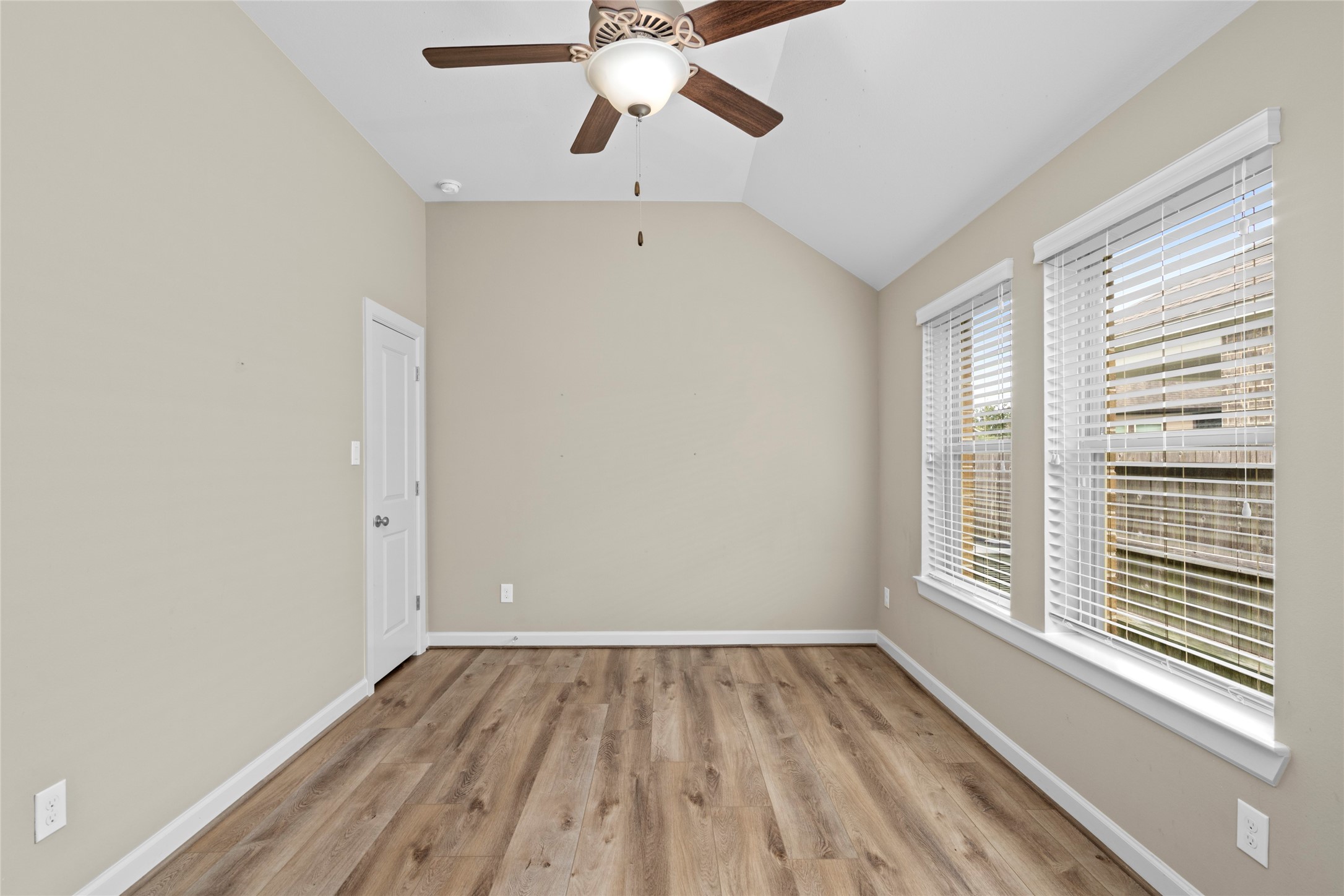 143 Castlegate Lane Houston, TX 77065 - Photo 22 of 33 Bedroom 2 with engineered hardwoods (2022). Seller added ceiling fans to all bedrooms in Dec 2017. LED specialized bulbs (2019)