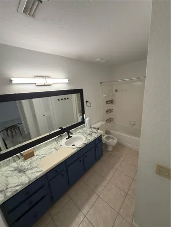 a room with stainless steel appliances granite countertop a sink and dishwasher