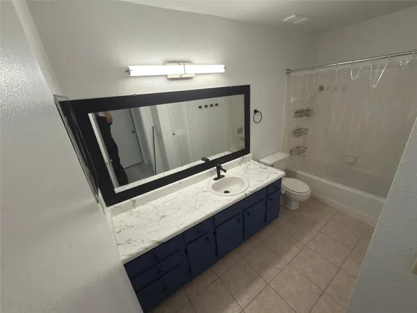 a bathroom with a sink double vanity granite tub shower and mirror
