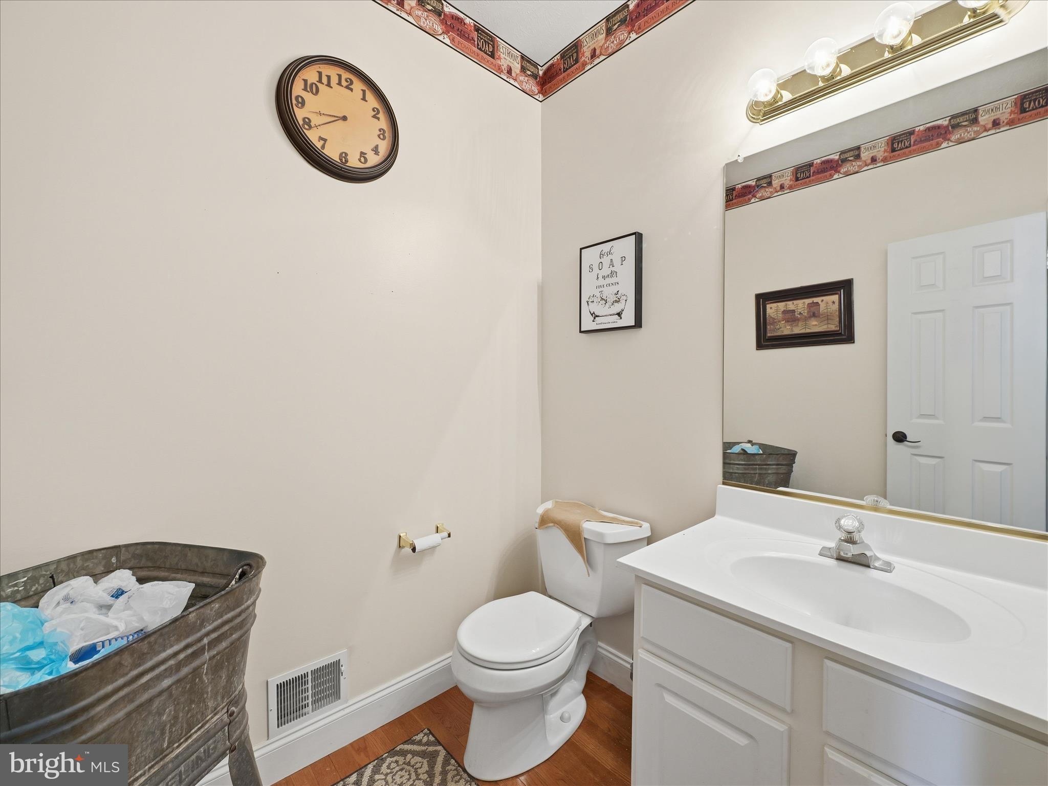 726 Doe Run Road Inwood, WV 25428 - Photo 43 of 68 a bathroom with a toilet a sink and a mirror