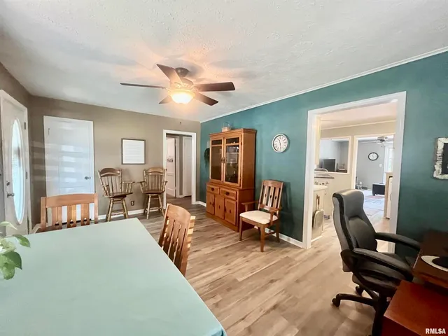 a living room with furniture two window and a flat screen tv