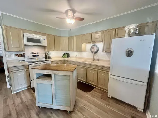 a kitchen with a sink a stove a refrigerator and a refrigerator