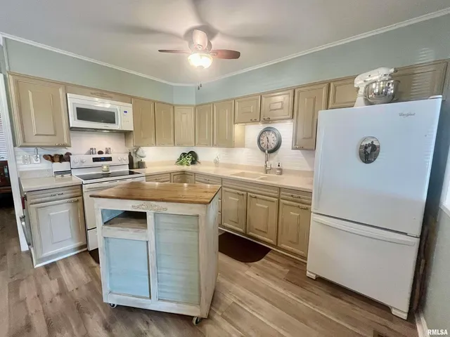 a kitchen with a sink a stove a refrigerator and a refrigerator