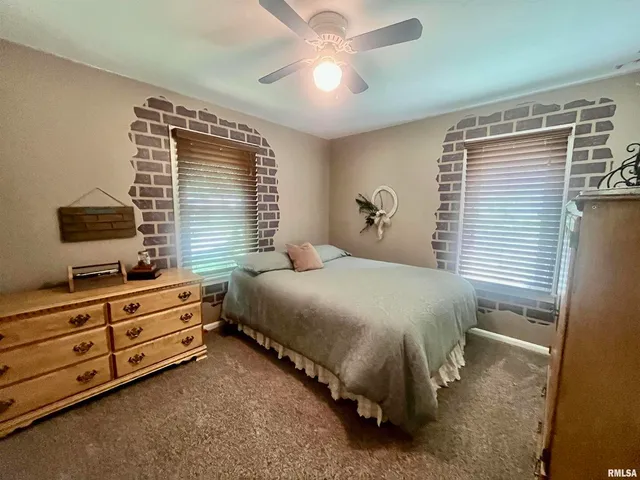 a spacious bedroom with a bed and a chandelier