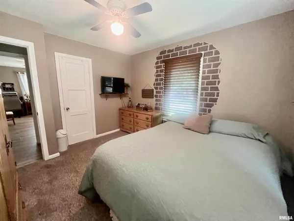 a bedroom with a bed and a television