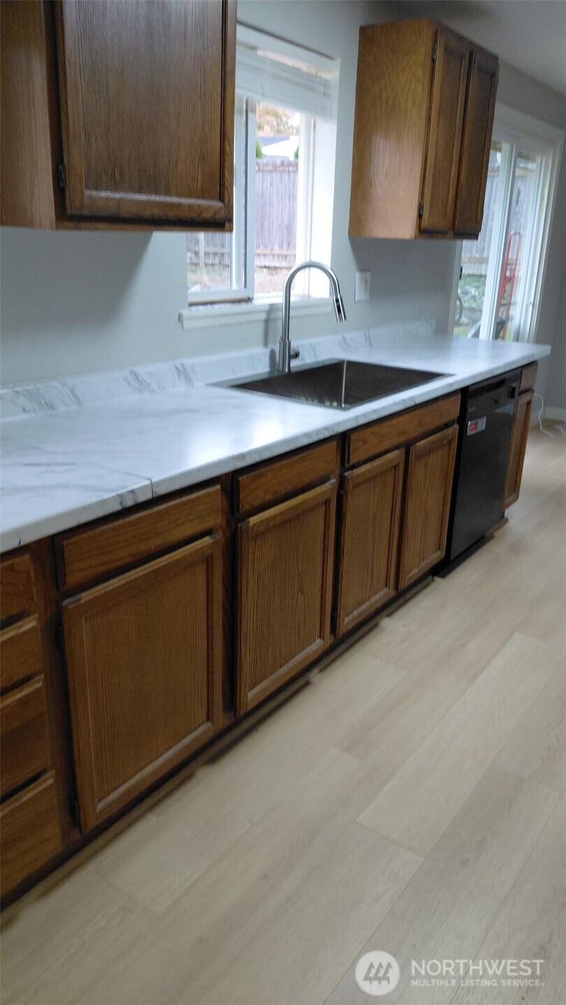 613 South 318th Place Federal Way, WA 98003 - Photo 4 of 17 a kitchen with a sink and cabinets