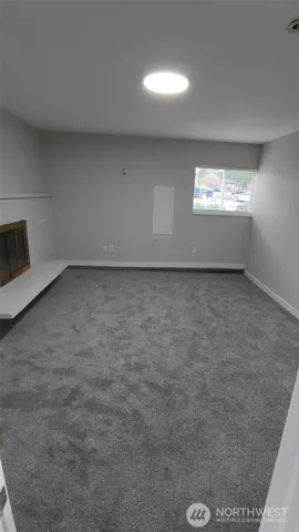 a view of an empty room and a window
