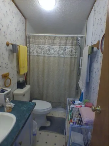 a bedroom with a bed and a dresser in it