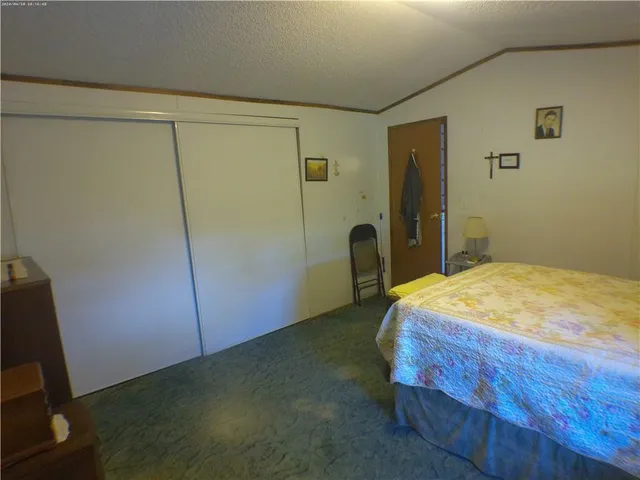 a living room with furniture a bookshelf and a window