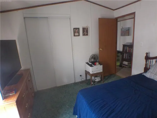a bathroom with a granite countertop toilet sink and mirror