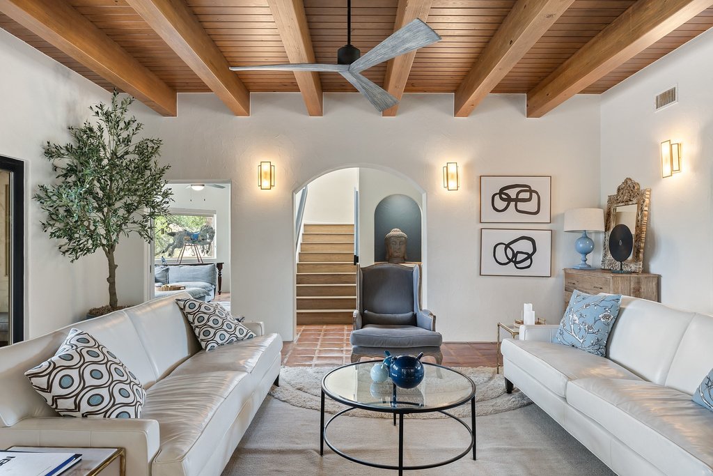 716 North Commons Ford Road Austin, TX 78733 - Photo 4 of 30 Living area featuring exposed wood beams, a ceiling fan, and arched doorways
