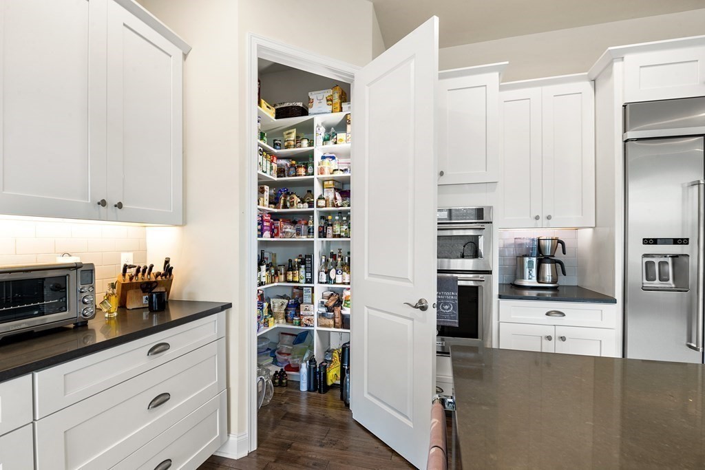 37 Pine Tree Drive, Unit 37 Methuen, MA 01844 - Photo 6 of 40 a kitchen with a refrigerator and cabinets