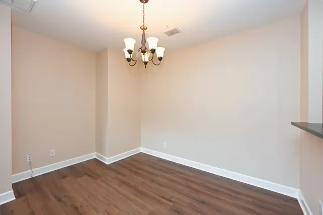 a view of a kitchen with wooden floor and a sink