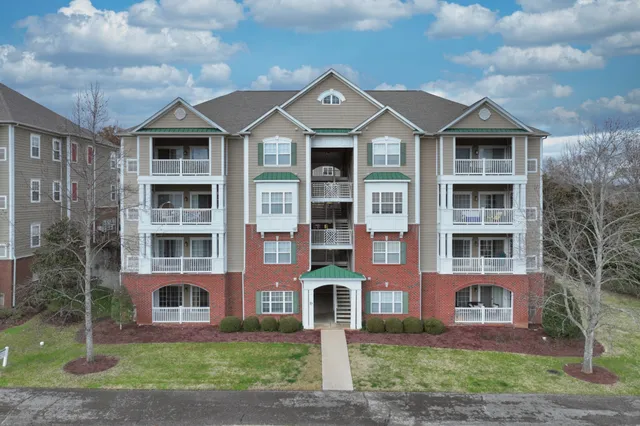 a view of a room with wooden floor and a kitchen