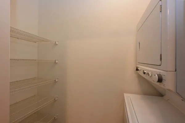 a view of staircase with a large window and wooden floor