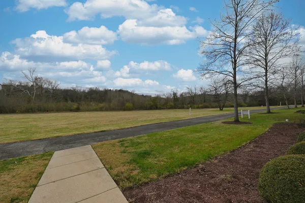 a front view of a building with a yard
