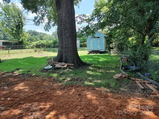 a view of a house with a yard and tree s