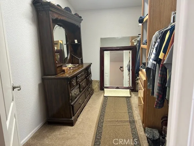 a hallway with sliding door and a mirror