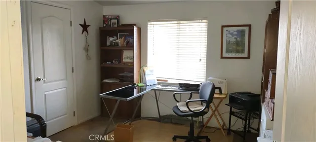 a view of a livingroom with furniture and a window