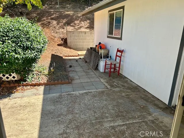 a view of two chairs in a backyard