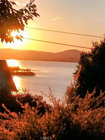 a view of ocean with green space