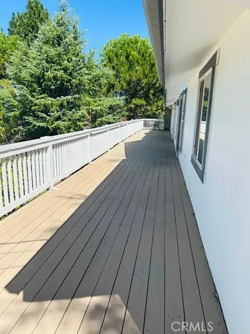 a view of balcony with wooden floor