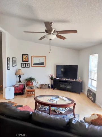 a living room with furniture pool table and a window