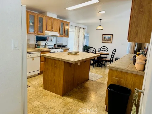 a kitchen with stainless steel appliances granite countertop a stove a sink a refrigerator and a microwave