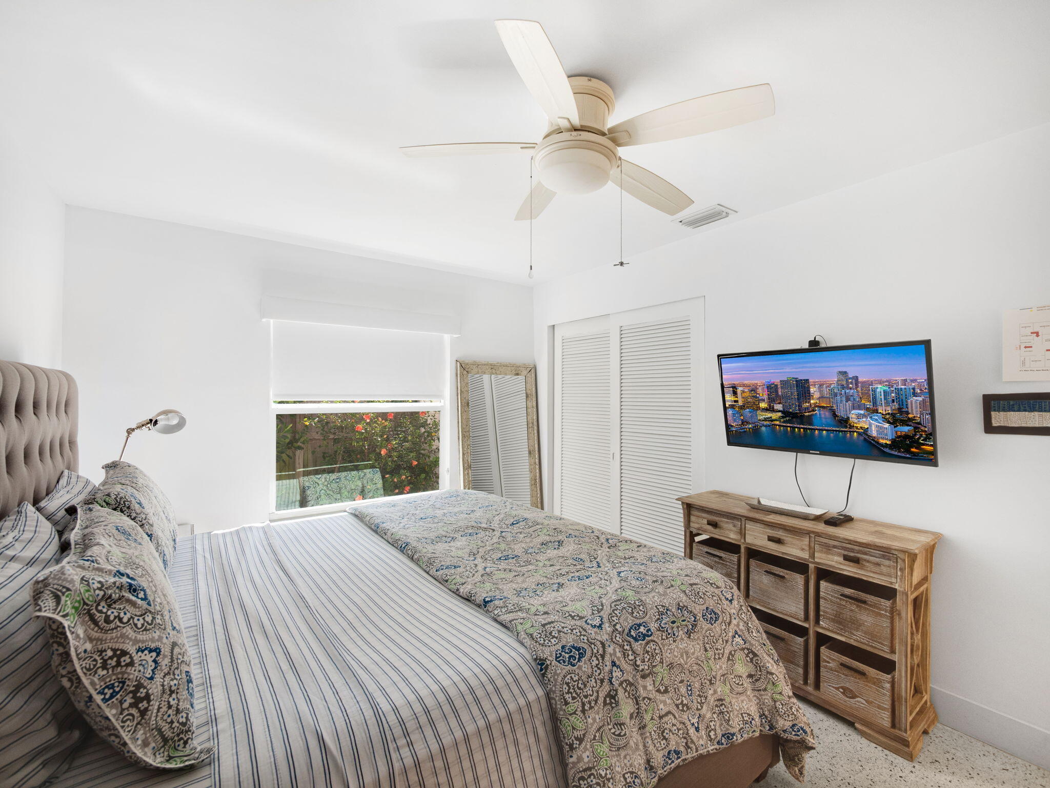 471 Mars Way Juno Beach, FL 33408 - Photo 15 of 29 a bedroom with a bed and a flat screen tv