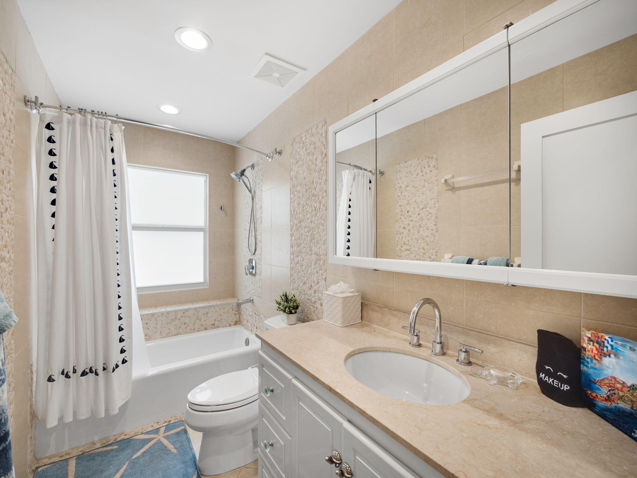 471 Mars Way Juno Beach, FL 33408 - Photo 19 of 29 a bathroom with a double vanity sink toilet mirror and bathtub