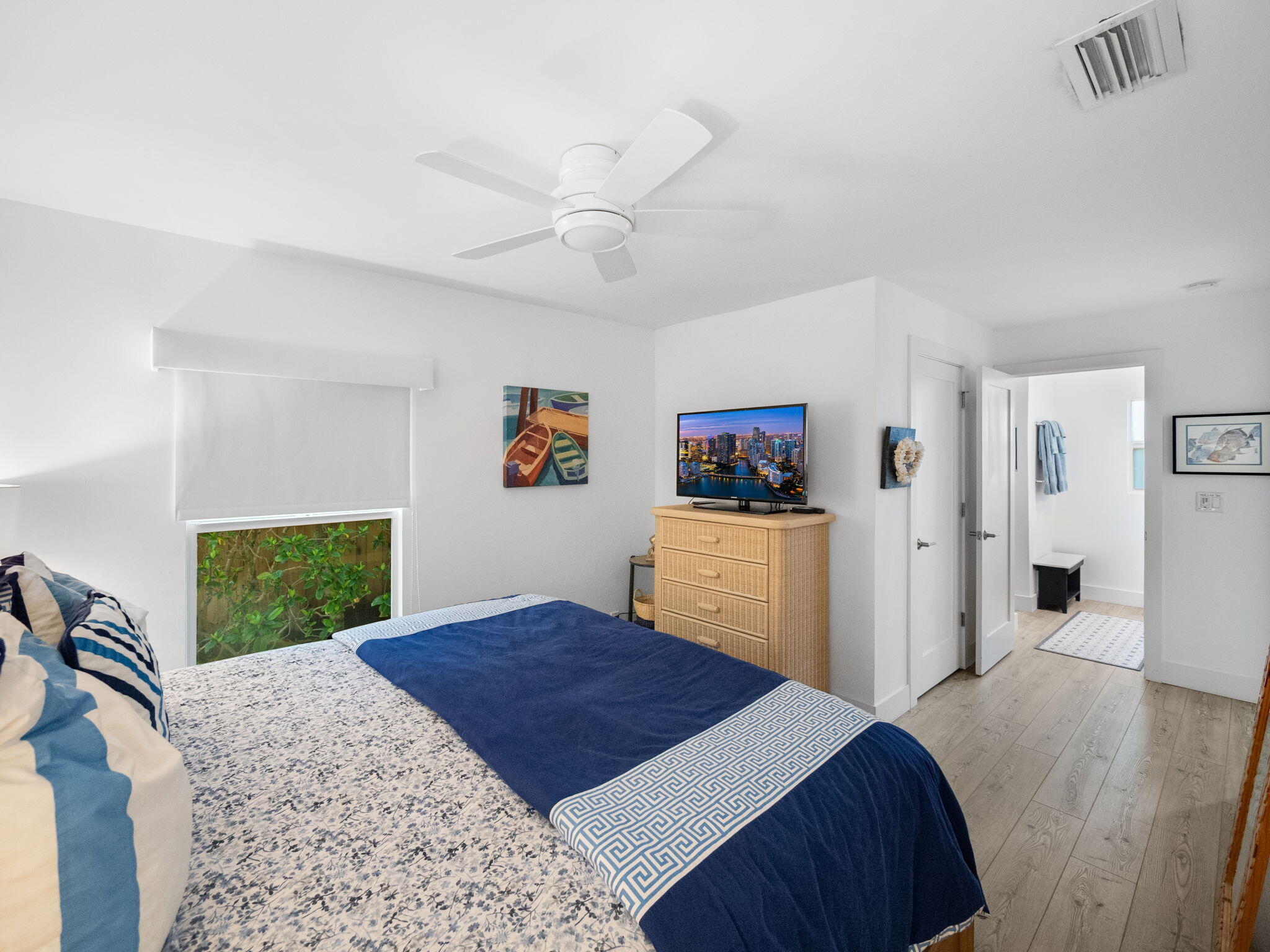 471 Mars Way Juno Beach, FL 33408 - Photo 20 of 29 a bedroom with a bed and a dresser in it