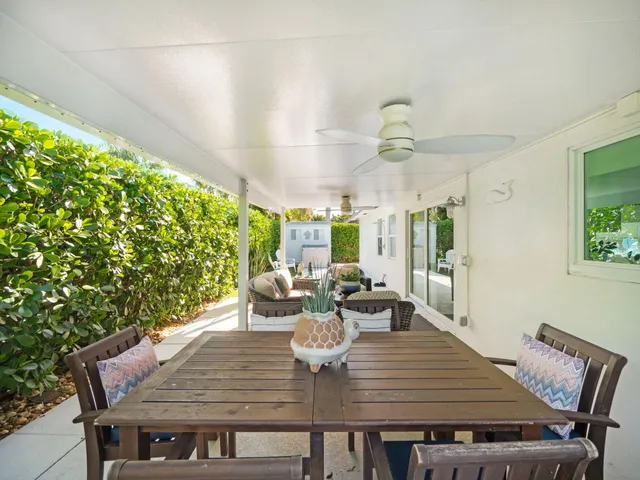 a outdoor living room with furniture and a potted plant