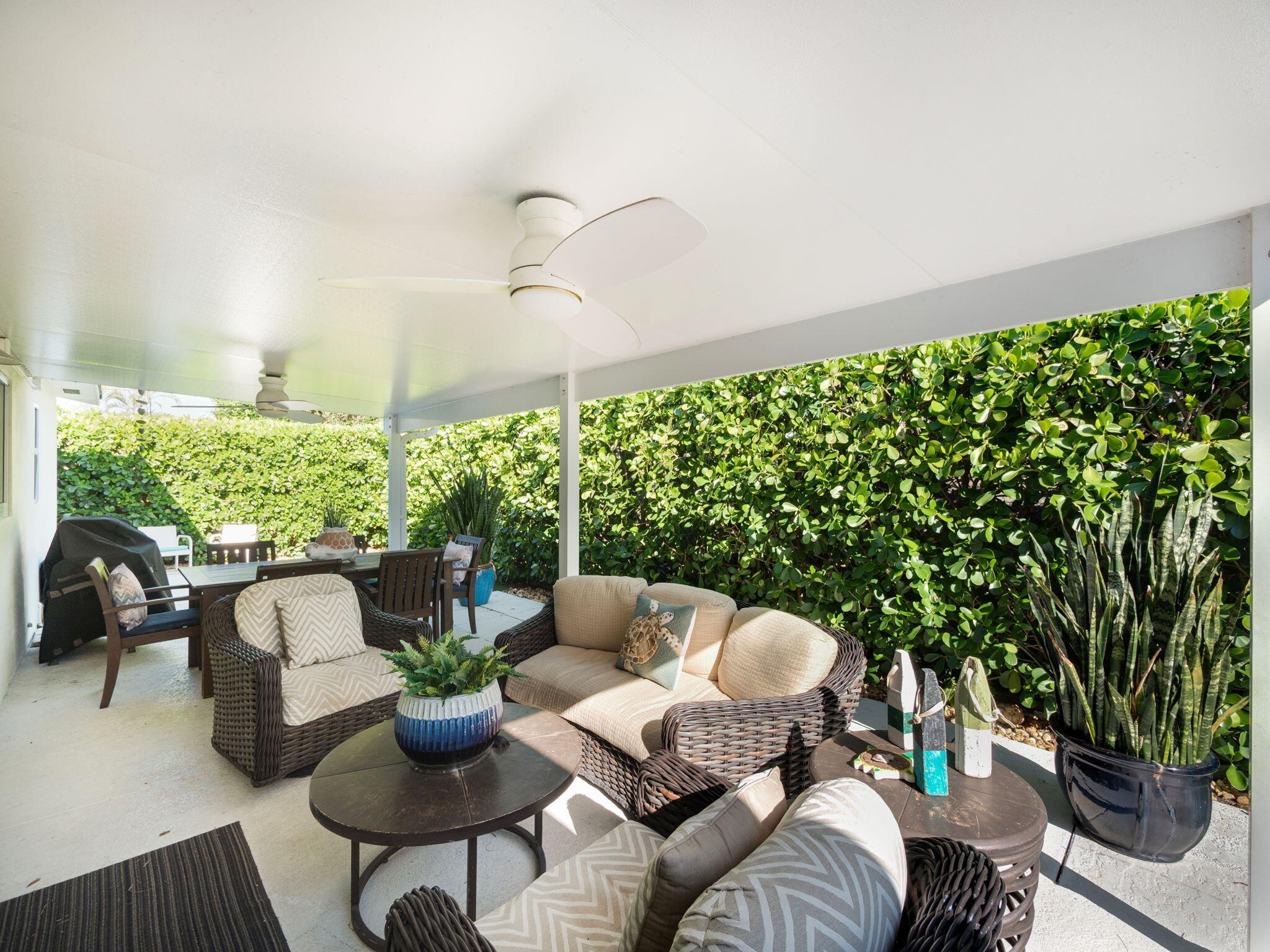 471 Mars Way Juno Beach, FL 33408 - Photo 25 of 29 a outdoor living room with furniture and a potted plant