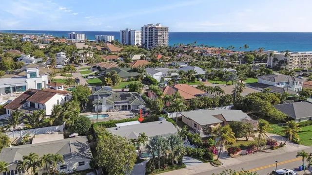 a view of a backyard with swimming pool and sitting area
