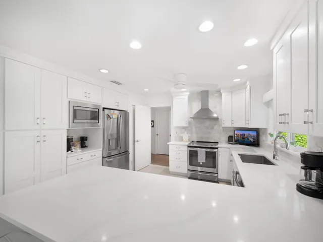a dining room with furniture and a kitchen view