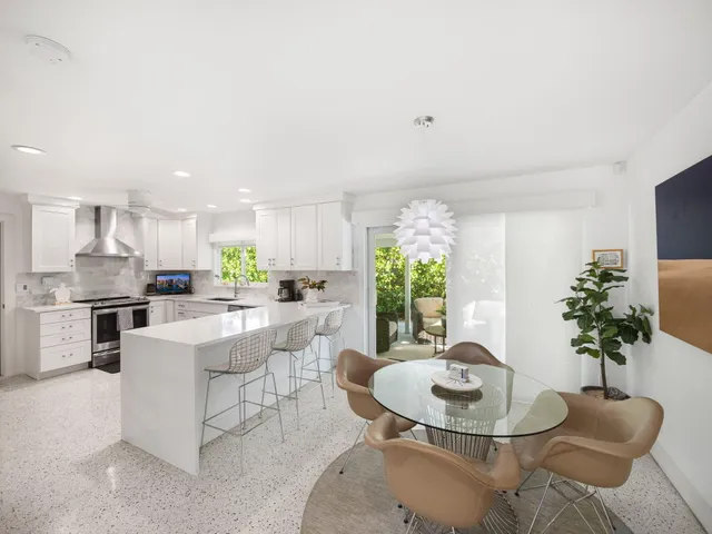 a living room with furniture kitchen and a chandelier