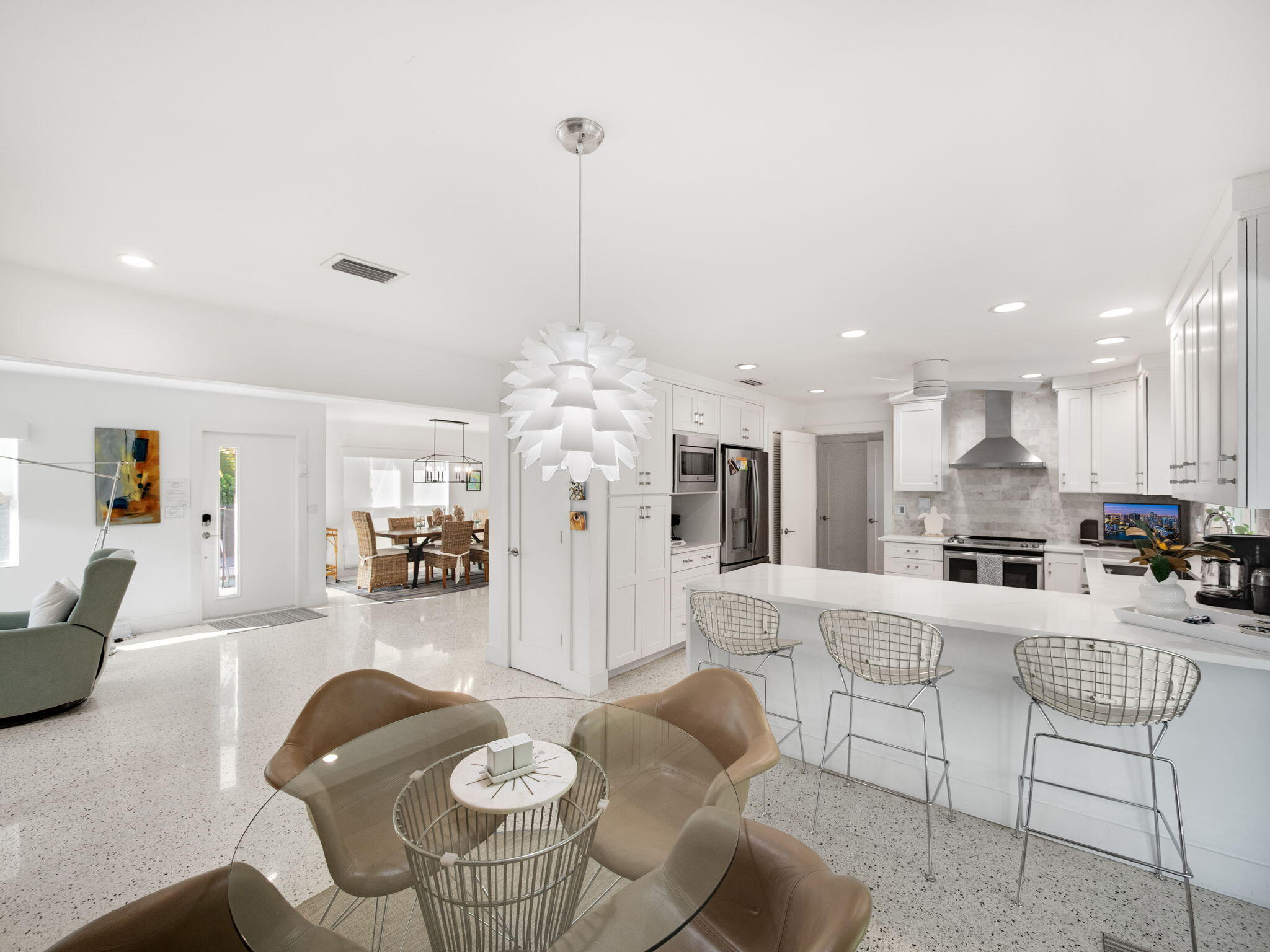471 Mars Way Juno Beach, FL 33408 - Photo 9 of 29 a living room with furniture kitchen and a chandelier