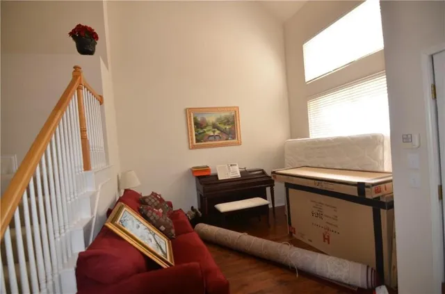 a view of staircase with wooden floor and a rug