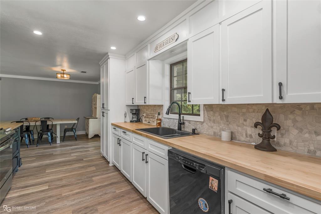 1426 Caney Lake Road Minden, LA 71055 - Photo 12 of 36 Kitchen featuring white shaker-style cabinetry, wood-finish countertops, and a mosaic tile backsplash