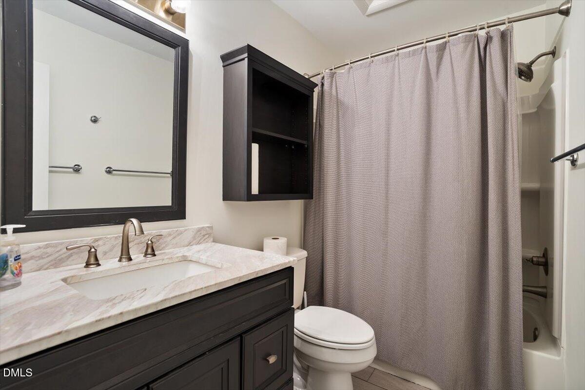 163 Springberry Lane Chapel Hill, NC 27517 - Photo 25 of 32 a bathroom with a granite countertop sink toilet and shower