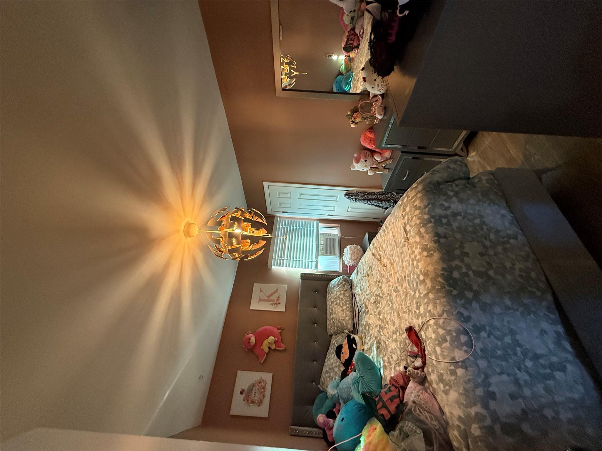 17 Hampton Road Shirley, NY 11967 - Photo 13 of 26 Bedroom featuring cooling unit and wood finished floors