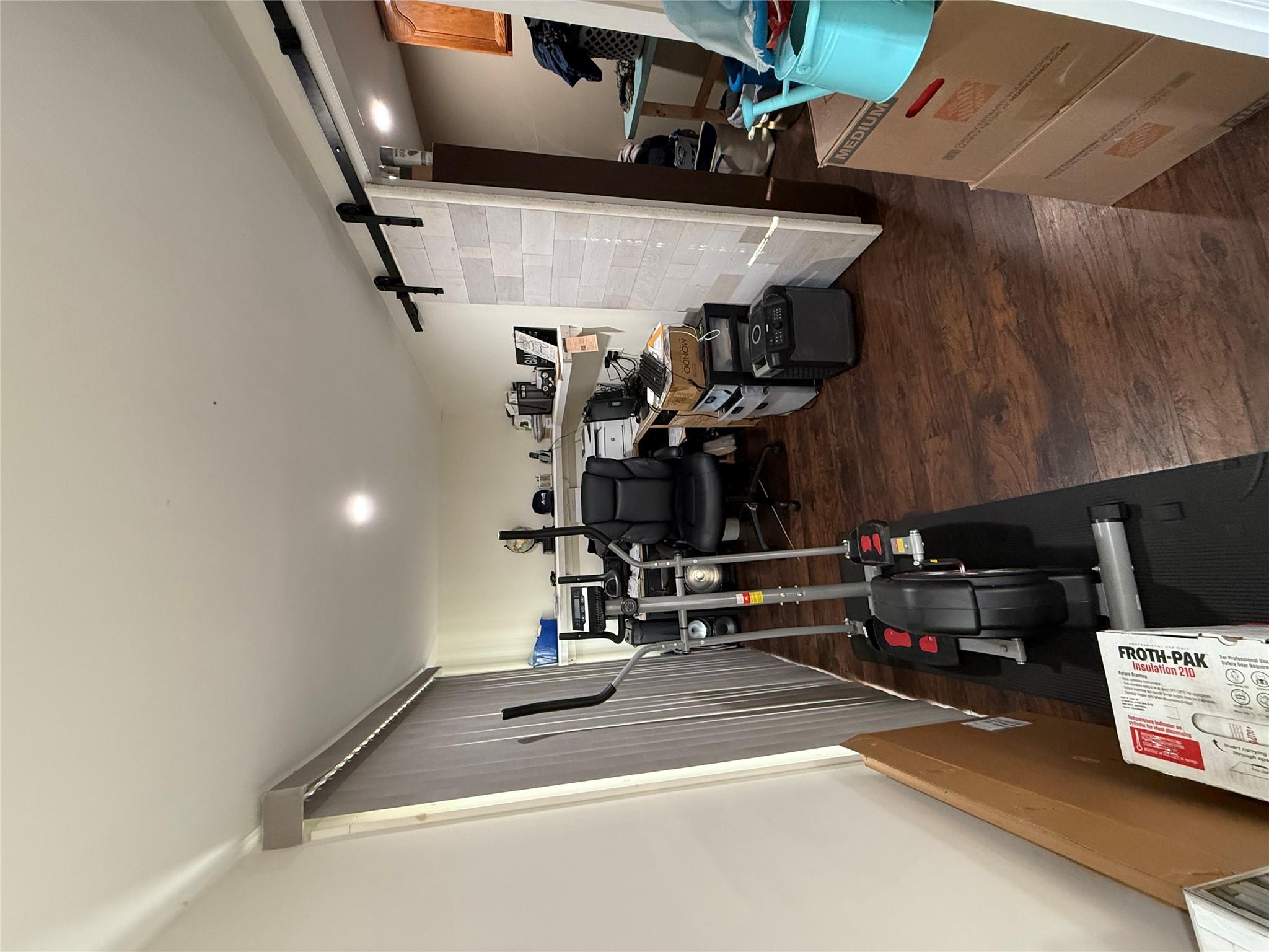 17 Hampton Road Shirley, NY 11967 - Photo 14 of 26 Exercise area featuring dark wood-style floors and a barn door